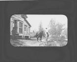 People and horses in front of store, Oak Lodge Trip