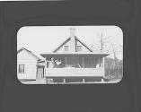 Women on farmhouse porch, Oak Lodge Trip