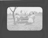 Woman next to Louise Gifford on bed, Oak Lodge Trip
