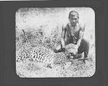 Native man with dead cheetah stabbed with knives