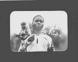 Man holding flowers with a monkey on his shoulder