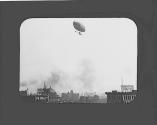 Blimp in sky over city