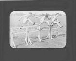 Men jumping hurdles