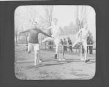 Men jumping hurdles