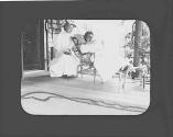 Josephine Dickman and friend on porch reading, Petersham Motor Trip