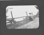Women sitting on fence on side of road, Petersham Motor Trip