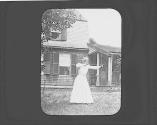 Josephine Dickman shooting bow and arrow in yard, Petersham Motor Trip
