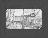 Women on porch of log cabin, Adirondacks Trip