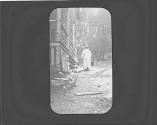 Woman outside cabin with bucket, Adirondacks Trip
