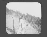 Mexican woman with baby near train tracks