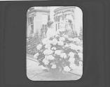 Newhalls posing by hydrangea in Eastman's garden