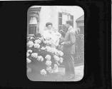 Newhalls posing by hydrangea in Eastman's garden