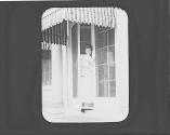 Nell Newhall in doorway