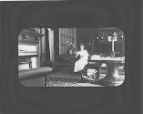 May Gifford sitting in West room by fireplace