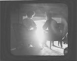 Man and woman sitting in front of fireplace