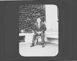 George Eastman seated outside