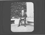 George Eastman seated outside