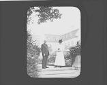 George Eastman and woman on pathway