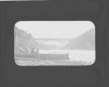 Women on shore watching river