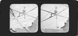 [Man crossing tightrope over Niagara Falls, from Canadian side]