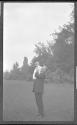 George Eastman holding Watson Newhall in garden