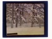 [View of side of structure, snow covered pines in winter]