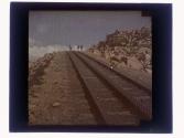 [Three people on railway tracks]