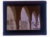 [Women standing in archway]