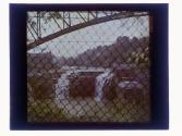 [Lower falls of the Genesee River through chain link fence]