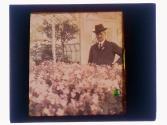 [Charles Zoller (?) in greenhouse]