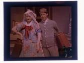[Man and women carrying suitcases]