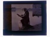 [Man sketching on pier]