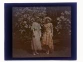 [Two women in front of lilacs]