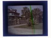 [View of house, stone fence and plants]