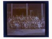 [Large group portrait in front of building]