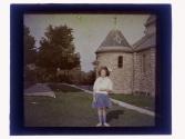 [Child in front of building]