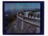 [People on cliff overlooking city]