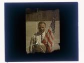 [Man holding American flag]