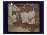 [Group of eight African American children standing in a line]