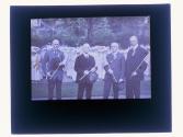 [GE and three unid. men holding flags]