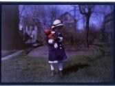 [Girl holding doll]