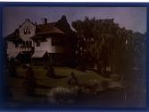 [House with trees and water]