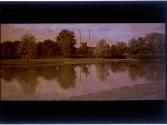 [Landscape with water and smoke stacks]