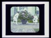 Dryden children playing on patio in garden