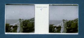 [Woman next to car overlooking water]