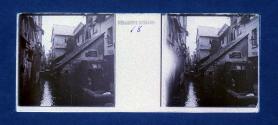 [Buildings and outdoor urinal along canal]