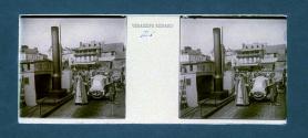 [Woman standing in front of car]