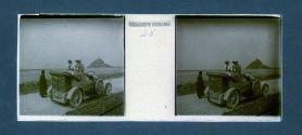 [Two women in car, castle on distant island]