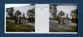 [Woman flanked by men on roadside]