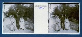 [Uniid. man posing with two children]